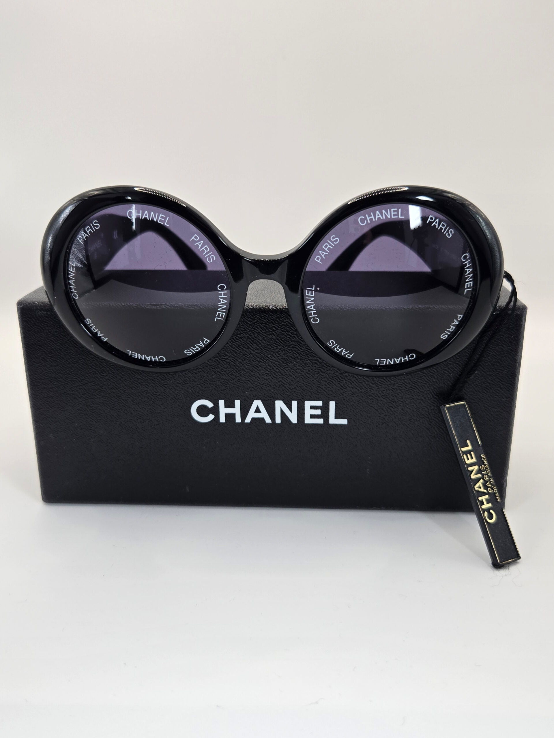 Chanel vintage round sunglasses black with Chanel Paris lettering and gold CC logo arms